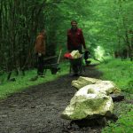Land Art installation Golden Rocks. Stones covered in gold leaf. Contrast between gold and mud. Artist Tanya Atanasova